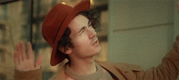 Remember that guy in the red hat? LIFE IS MUSIC HE IS A COMPOSER. He's walking down the street getting inspiration. 