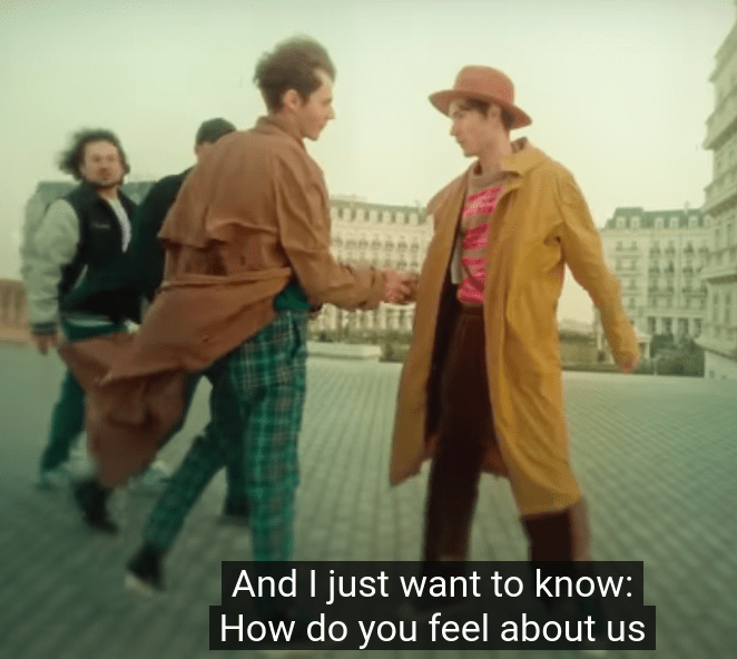 Bad Boy Twin and Red Hat Guy meet and do a very big handshake.
